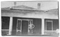 Photograph: [Man Standing on Flooded Porch]