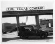 Photograph: [Car in Front of Texas Company Sign]