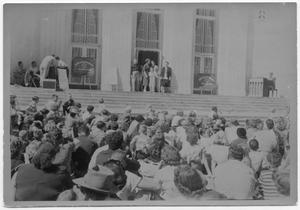 [Crowd Seated in Front of Building]