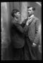 Photograph: [Lon Kelley fixing the tie of another man]