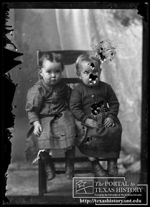 [Two seated children]
