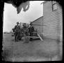 Photograph: [Three men posing with farming machinery]
