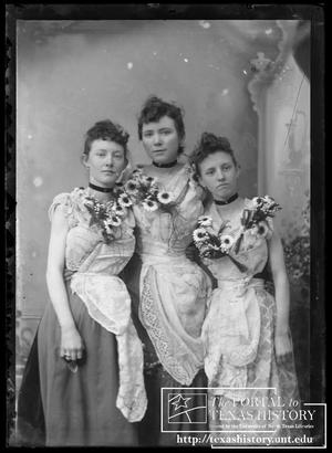[Three young women adorned with flowers]