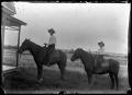 Photograph: [Man and a boy on horses]