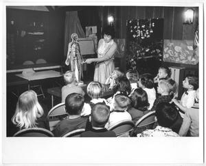 [Photograph of a Woman Discussing the Human Body with Young Children]