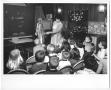 Photograph: [Photograph of a Woman Discussing the Human Body with Young Children]