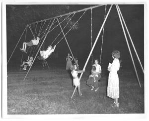 [Photograph of Children Swinging at a Dallas Park]