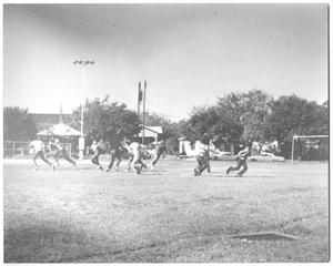 [Photograph of Teen Boys Playing Football in a Park]