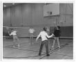 Photograph: [Photograph of Students Playing Badminton in a School Gymnasium]