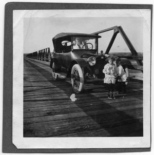 Primary view of object titled '[Children in front of car on bridge]'.