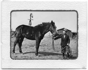 Primary view of object titled '[Fleet Pruden holding horse reins]'.