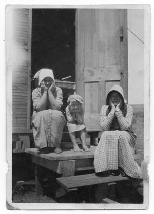 [Women and child on steps]