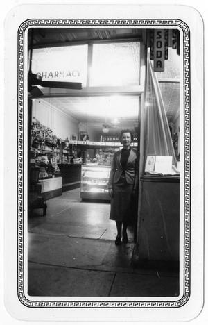 Primary view of object titled '[Etha Pruden at the Pruden Drug Store]'.