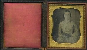 [A photograph of an unidentified woman, inside of a wood case]