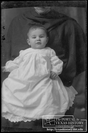 [Baby in a white gown]
