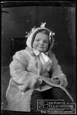 [Young child wearing a fur coat]