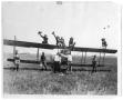Photograph: Group on the wing [of a bi-plane], c. 1915