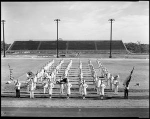 Primary view of object titled '[Denton Teacher's College marching band poses on football field]'.