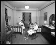 Photograph: [Two unidentified women pose inside TSCW dormitory room]