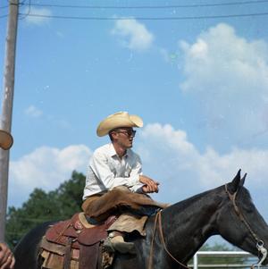 Primary view of object titled '[Cowboy on his horse at Cowtown Daze]'.