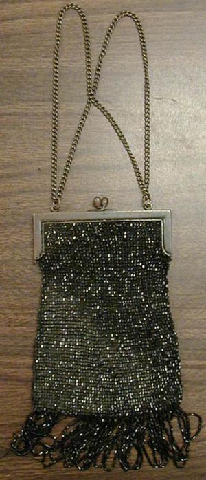 black purse, beads and tassels on bottom.  Metal clasp.