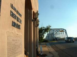 [Llano County Historical Museum with bridge in background]