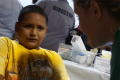 Primary view of [Student participates in health screening during a back to school fair]