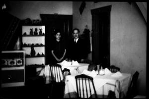 Primary view of object titled '[Felix Tijerina and young woman inside a restaurant]'.