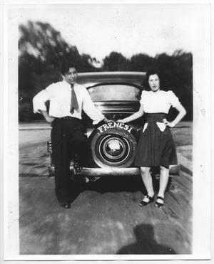 [Joe Ortiz and woman posing by a car]