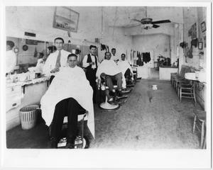 [Barbers and Men inside La Preferencia Barber Shop]