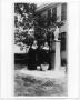 Photograph: [Two nuns standing next to a statue of Mary]