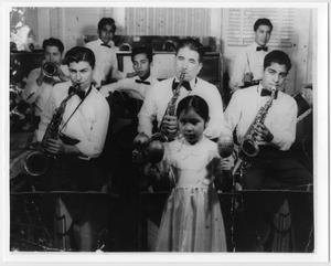 [Photograph of the Kido Zapata Trio playing with a little girl]