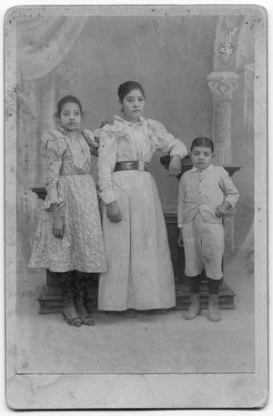 [Photograph of two girls and a boy]