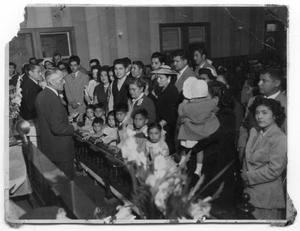 Primary view of object titled '[Baptism of thee children at El Mesias Church]'.