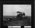 Photograph: [Farmers Sitting on Tractor]