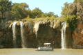Thumbnail image of item number 1 in: '[Tour boat passes a cliff with multiple waterfalls]'.