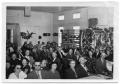 Photograph: [Group of People Seated in a Room]