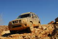Thumbnail image of item number 1 in: '[Dirty SUV  descending rocky slope]'.