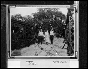 [Three Individuals on the Tres Palaicios Swing Bridge]
