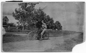 [Young Man on Bicycle with Dog]