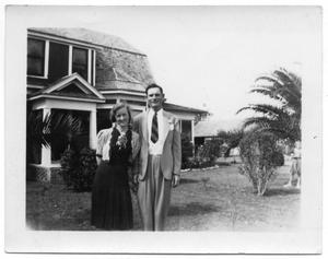 [Young Woman and Man in Front of House]