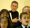 Primary view of [Children sing in front of a Priest]