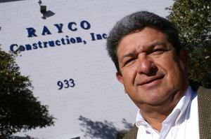 Primary view of object titled '[Ray Gomez in front of building]'.
