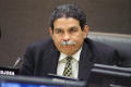 Photograph: [Michael Hinojosa sitting at table with microphone]