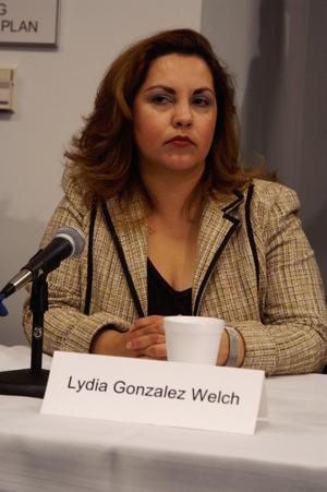 Primary view of object titled '[Lydia Gonzalez Welch sitting at table with microphone]'.