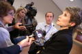 Primary view of [Laura Miller speaking into news microphones]