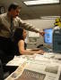 Photograph: [Juan A. Ramos and woman at computer with "La Estrella" in foreground]