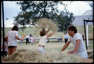 [Young Child Playing in Hay]