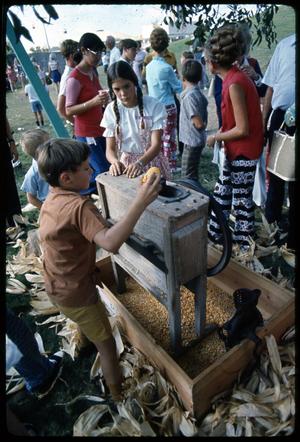 [Children Learn How to Operate Antique Corn Sheller]