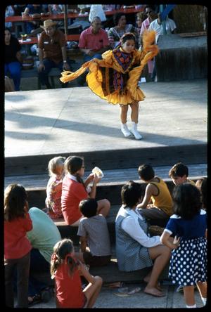 Primary view of object titled '[Young Mexican-American Girl Dancing Onstage]'.